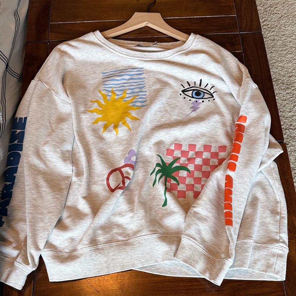 Cream Graphic Sweatshirt with Colorful Beach Motifs